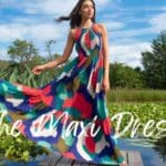 A vibrant maxi dress flows gracefully in a natural lakeside setting, perfect for adding style to your summer wardrobe