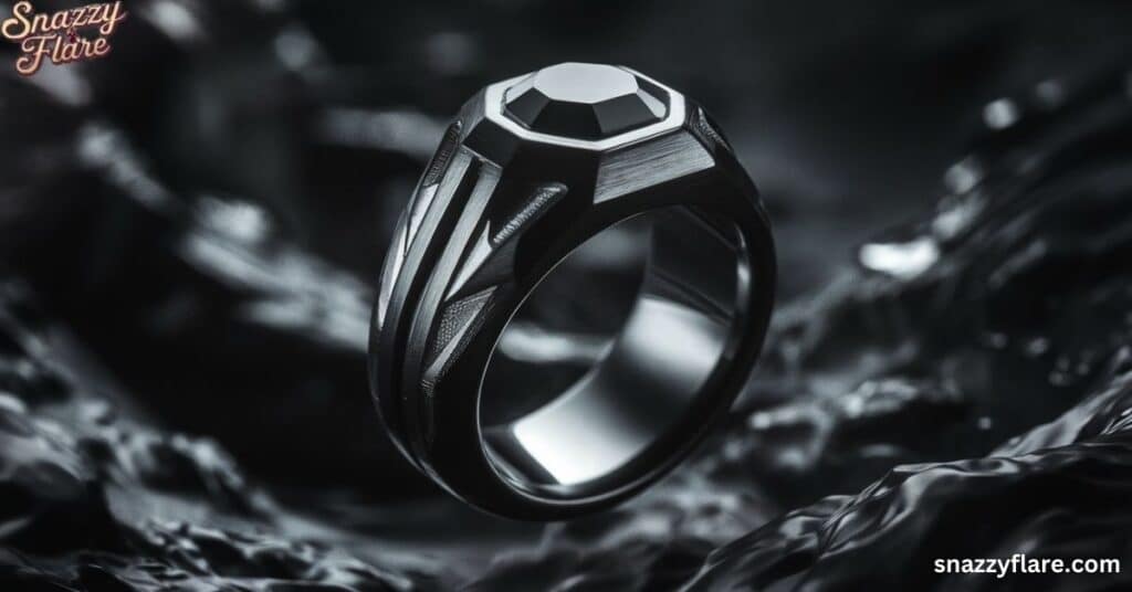 A sleek black gemstone ring with intricate design details, displayed on a dark, textured background