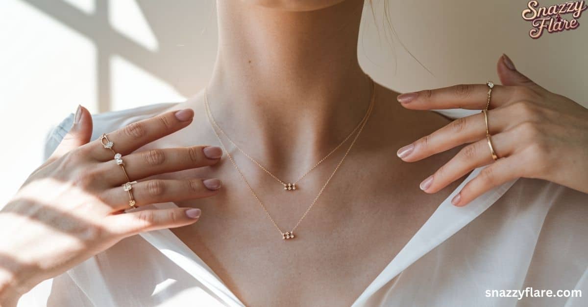 Close-up of a person wearing delicate gold necklaces and rings from Snazzy Flare.