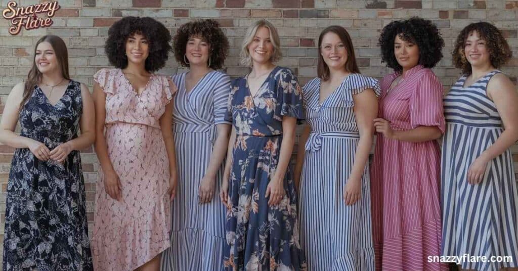 Seven women wearing various patterned summer dresses in front of a brick wall