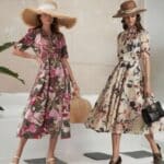 Two women in floral midaxi dresses and hats, standing by plants. snazzyflare.com