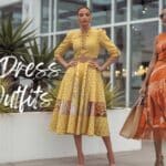 wo women in stylish yellow and orange dresses, standing by modern architecture.