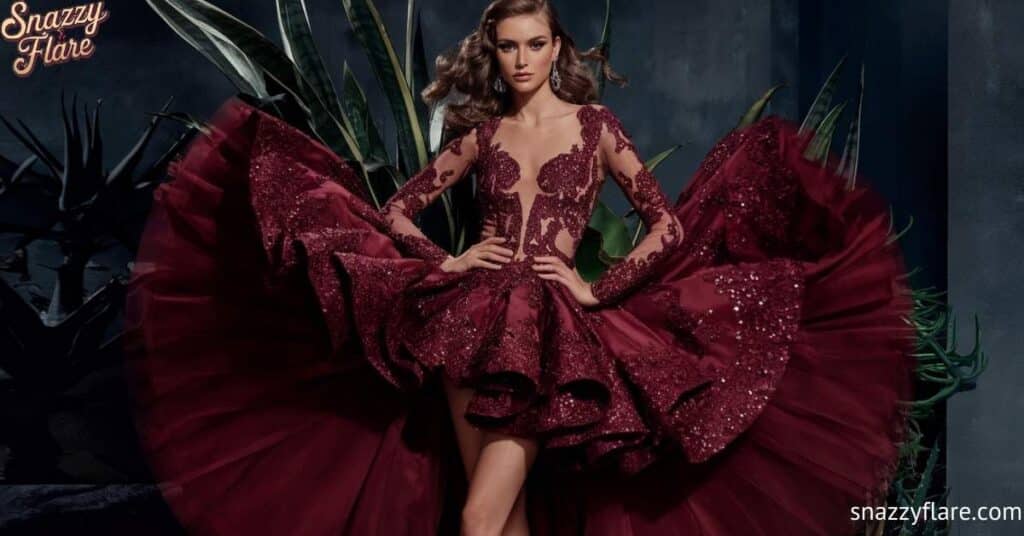 Woman in a burgundy gown with intricate lace and sequins, posing dramatically